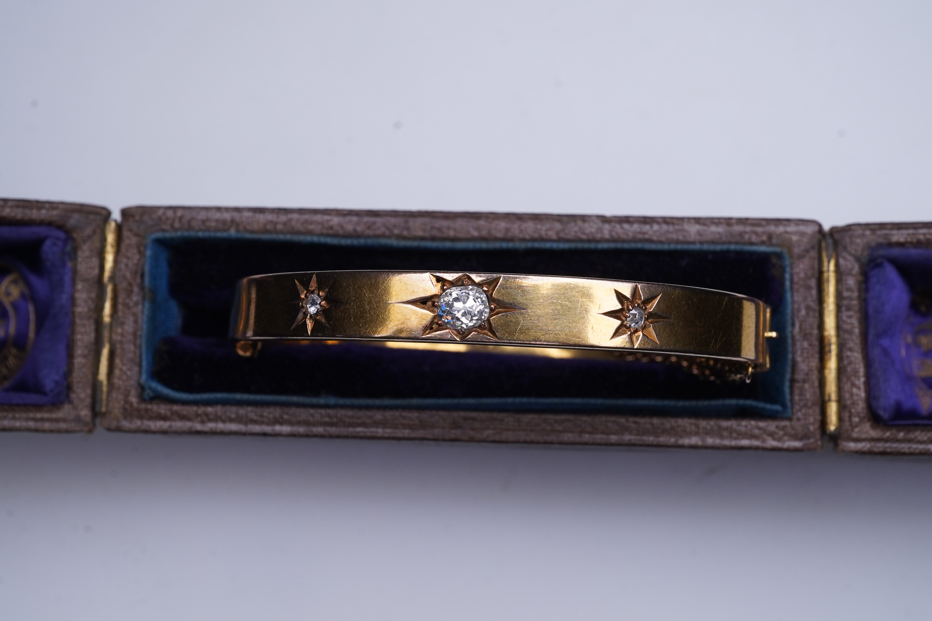 An Edwardian 15ct gold and diamond bangle, circa 1904